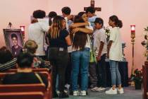 Mourners hug and grieve at Angel Naranjo’s casket during a visitation at Palm Downtown M ...